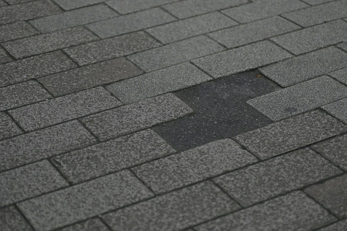 Close-up of an asphalt shingle roof with one shingle missing
