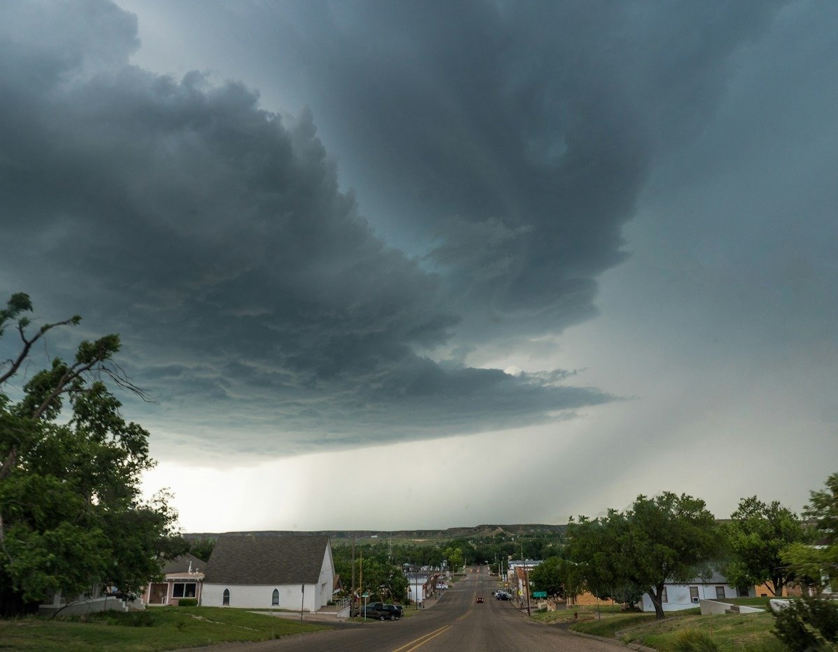 Dark storm clouds and rain moving over a small-town main street